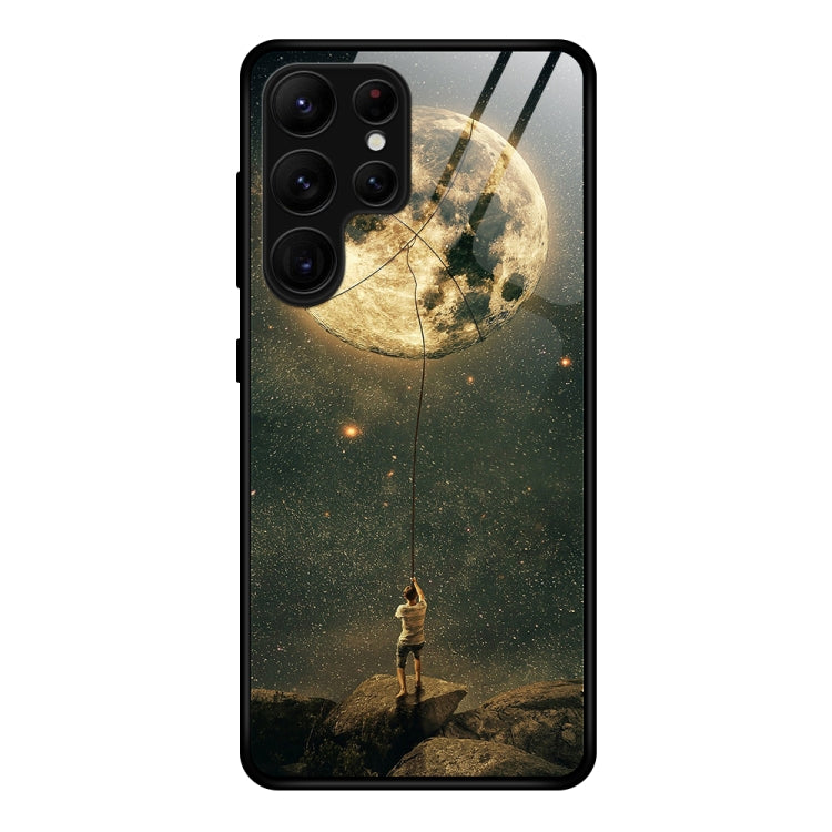 Glass phone case with moon and starry astronaut scene in dark tones