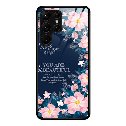 Glass phone case with pink flowers and blue background, with camera cutouts