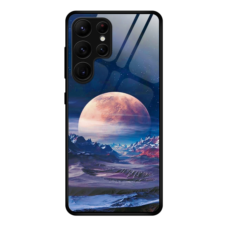 Glass phone case with large red-orange moon and mountain landscape