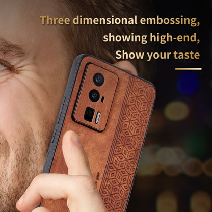 Brown embossed phone case close-up with camera cutout and textured geometric pattern