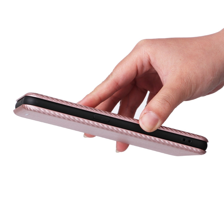 Pink flip phone case held in hand, showing side button and port cutouts