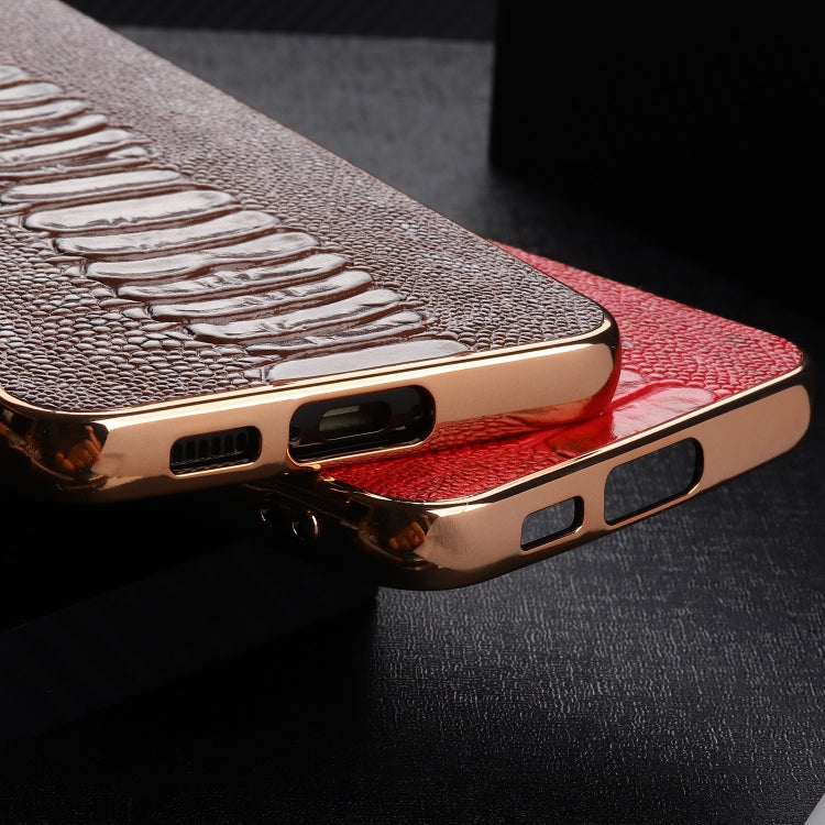 Red genuine leather phone case showing side buttons, ports, and gold-tone frame