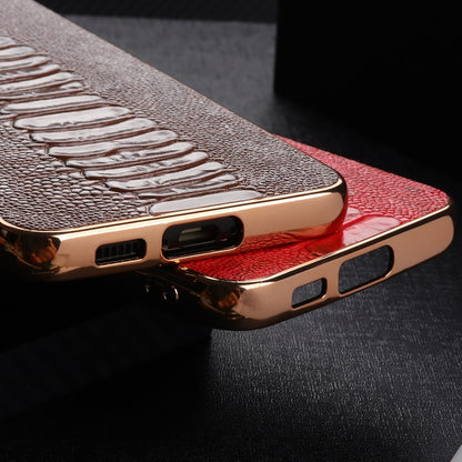 Red genuine leather phone case showing side buttons, ports, and gold-tone frame