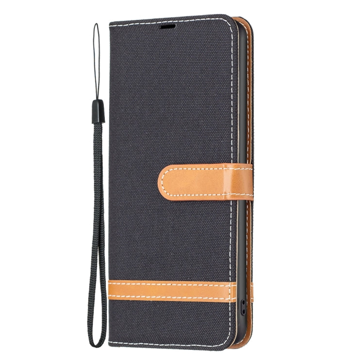 Dark gray denim-texture leather phone case with tan wrist strap and stitched bands