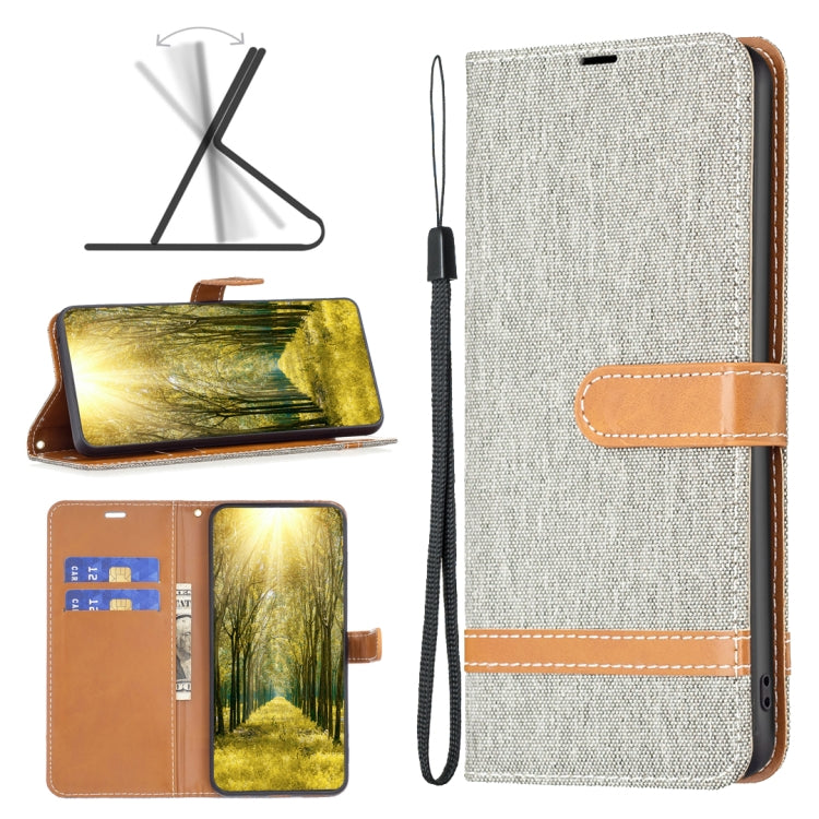 Light gray denim-texture leather phone case with tan strap and stitched horizontal bands
