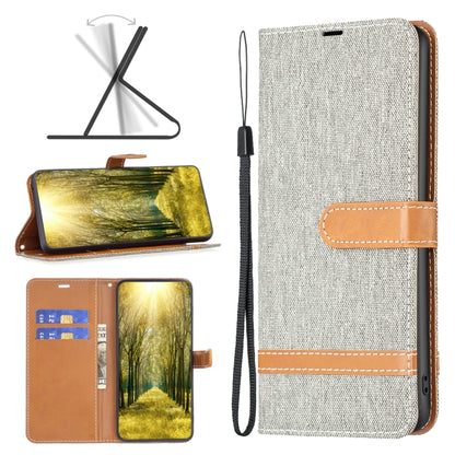 Light gray denim-texture leather phone case with tan strap and stitched horizontal bands