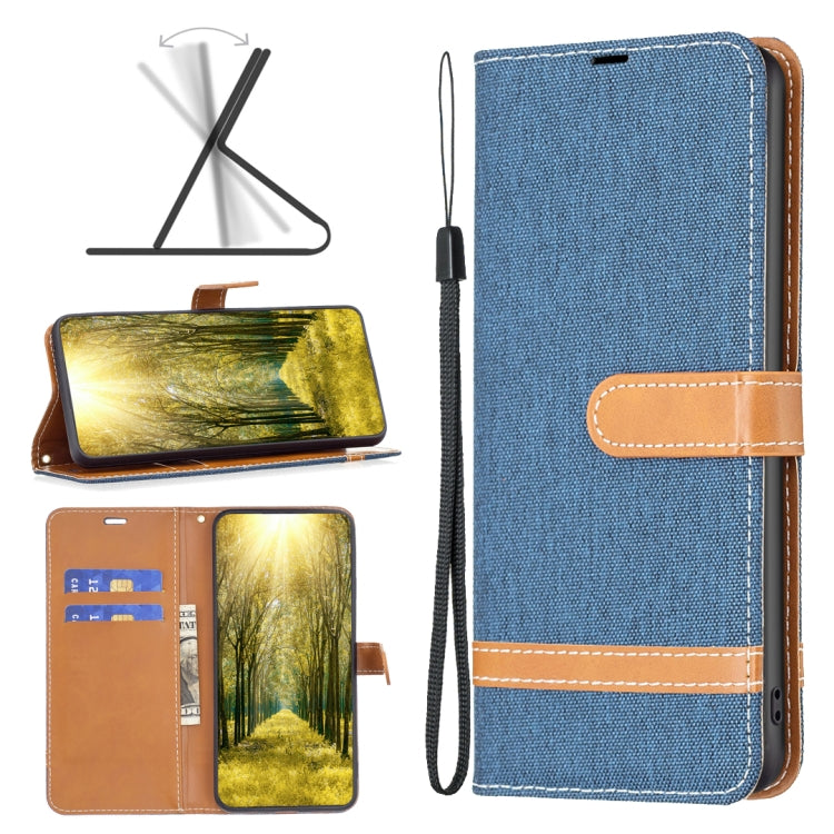 Blue denim-texture leather phone case with tan wrist strap and stitched horizontal band