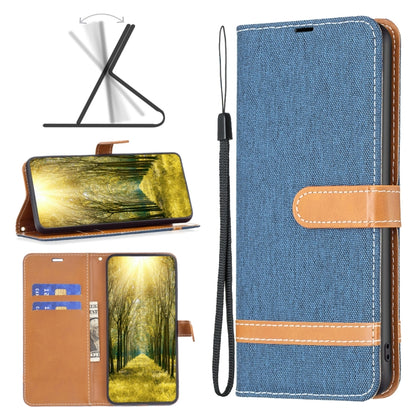 Blue denim-texture leather phone case with tan wrist strap and stitched horizontal band