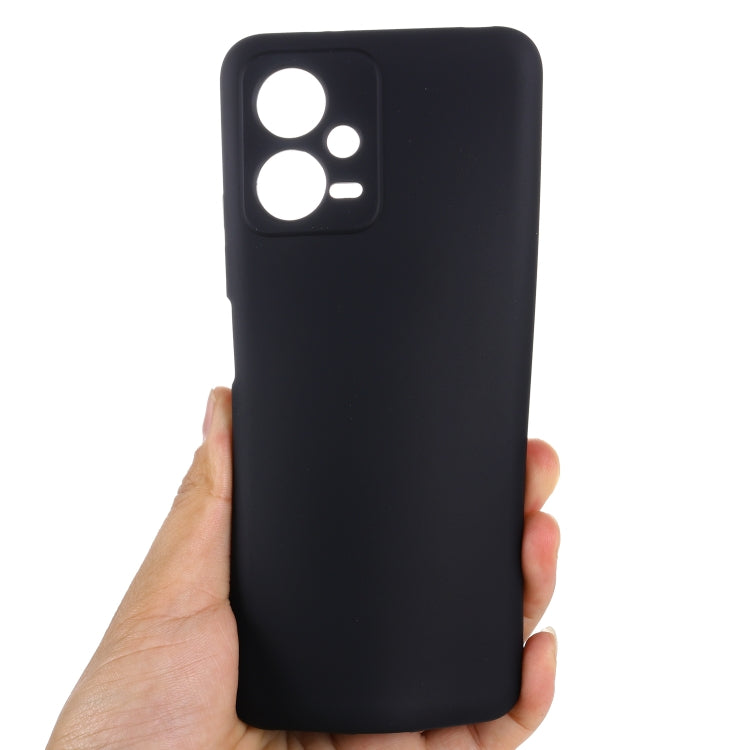Black liquid silicone phone case with raised camera cutouts, hand-held