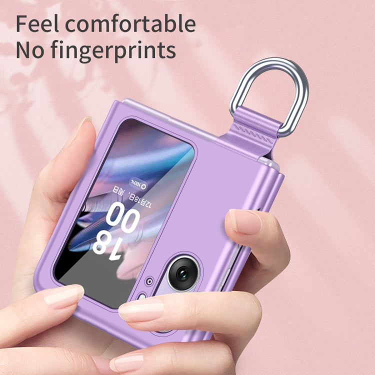 Purple ring-buckle flip phone case held in hand, showing front camera area