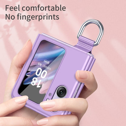 Purple ring-buckle flip phone case held in hand, showing front camera area