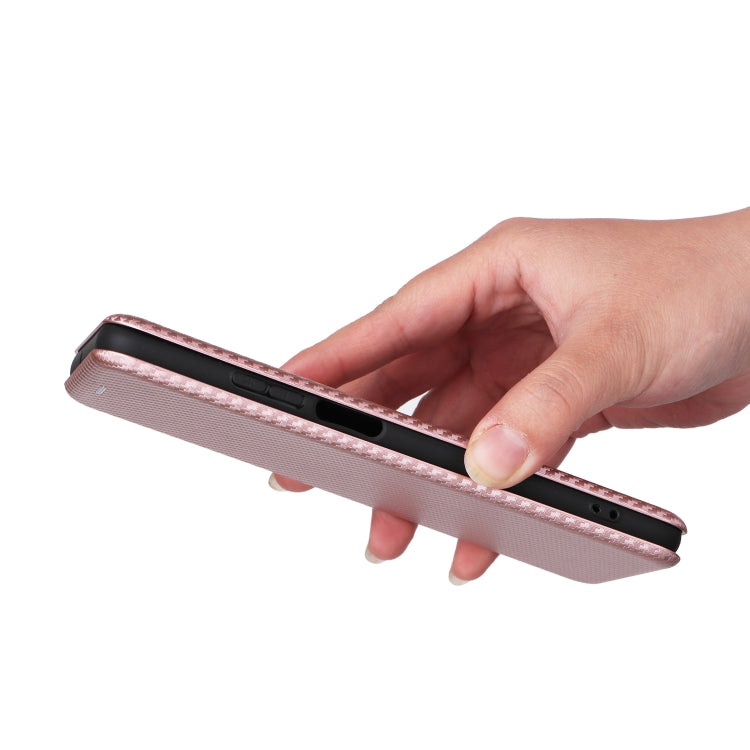 Pink flip phone case held in hand, side buttons and port opening visible
