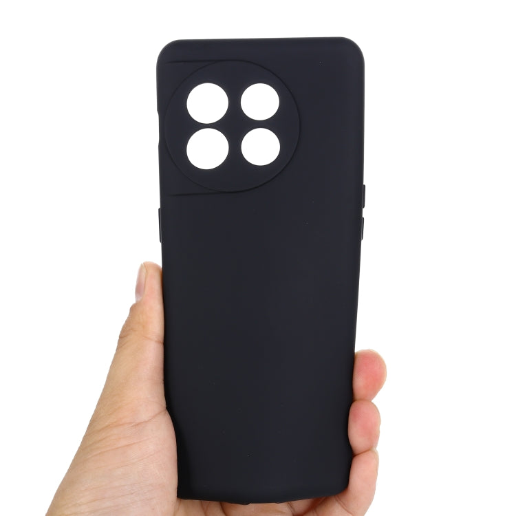 Black liquid silicone phone case held in hand, back with camera cutouts