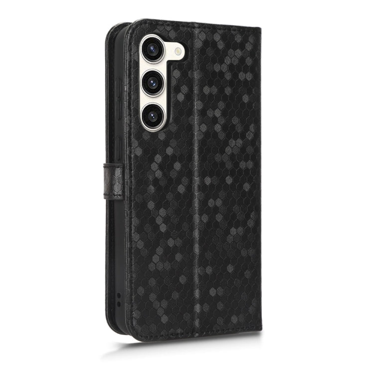 Black honeycomb dot leather phone case with side strap and raised camera cutouts