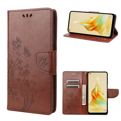 Brown leather phone wallet case with embossed butterfly-and-flower pattern, folio stand, card slots