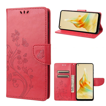 Red leather phone wallet case with embossed butterfly-and-flower pattern, folio stand, card slots