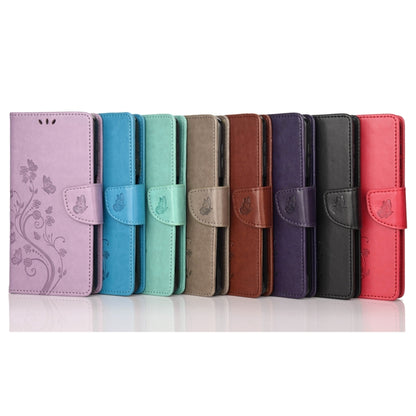 Assorted leather folio phone cases with butterfly flower pattern in multiple colors