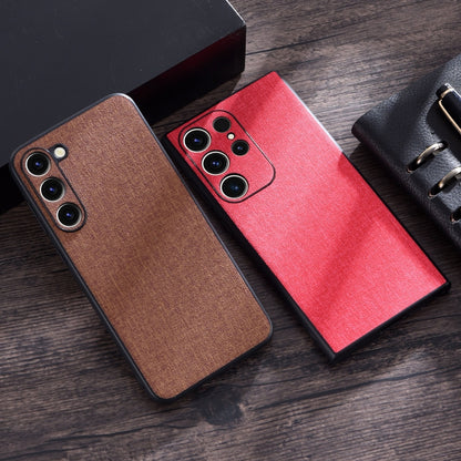 Cloth-texture phone cases in brown and red with camera lens cutouts