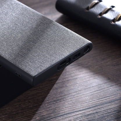 Grey cloth-texture phone case bottom edge with speaker and charging openings