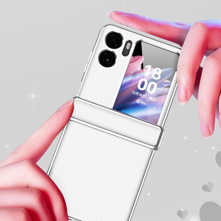 White magnetic flip phone case with textured litchi pattern, held in hands for close-up