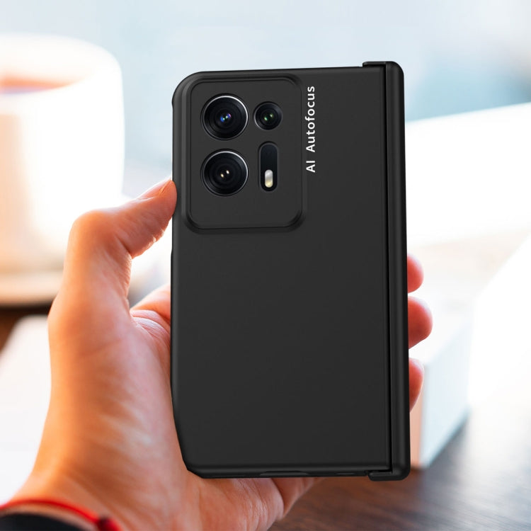 Black folding phone case held in hand with rear camera cutouts and kickstand panel