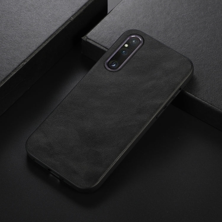 Black cowhide-texture PU phone case close-up with camera cutout and side buttons