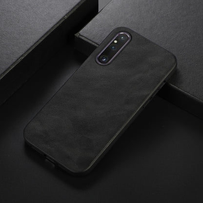 Black cowhide-texture PU phone case close-up with camera cutout and side buttons