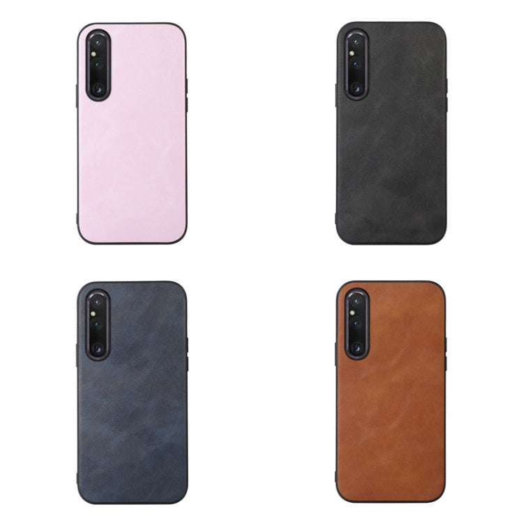 Cowhide-texture PU phone cases in pink, black, dark blue, and brown with camera cutouts