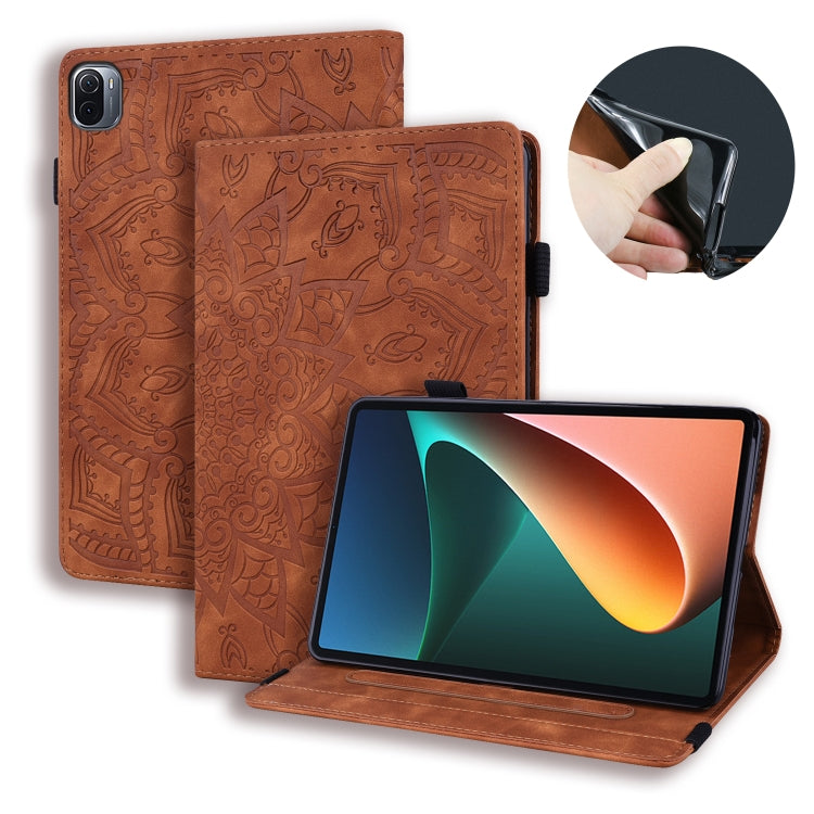 Brown embossed leather tablet flip case with stand and magnetic closure.