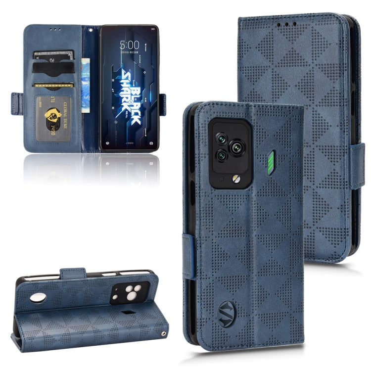 Blue leather folio phone case with symmetrical triangle pattern, triple-camera cutout, strap