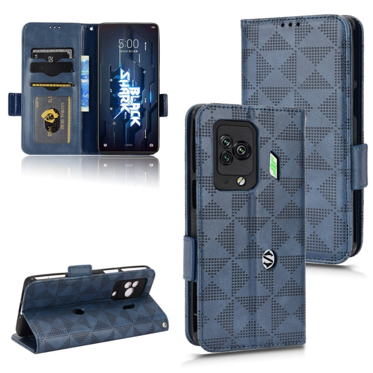 Blue leather folio phone case with symmetrical triangle pattern, wallet flap, side strap
