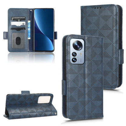 Blue leather folio phone case with symmetrical triangle pattern and triple-camera cutout, strap