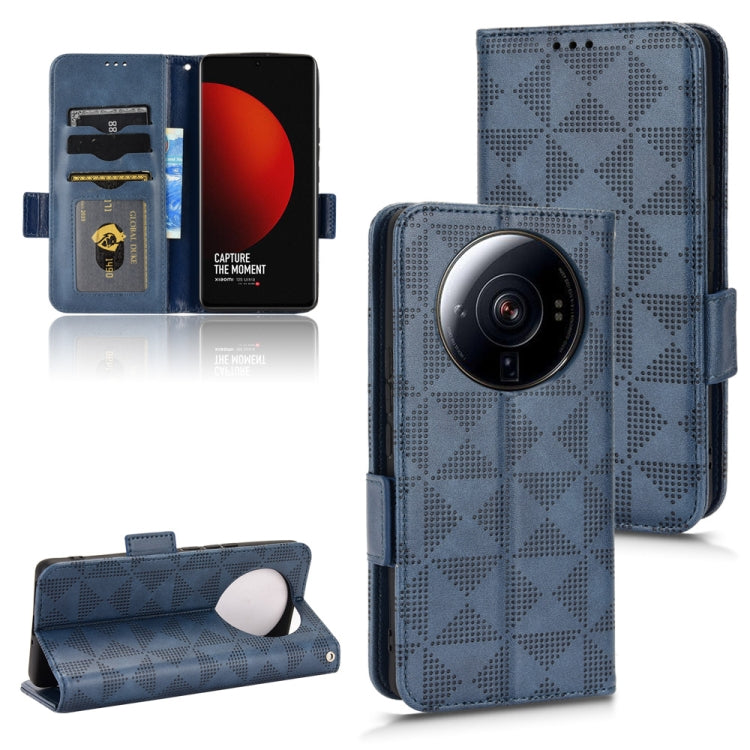 Blue leather-look folio phone case with symmetrical triangle pattern and side button cutouts