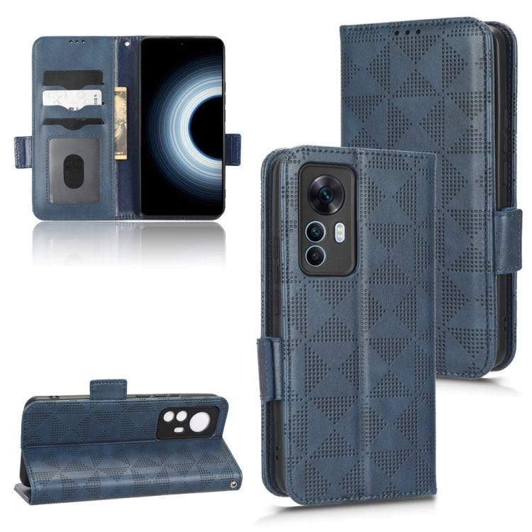 Blue leather folio phone case with symmetrical triangle pattern and kickstand, magnetic strap