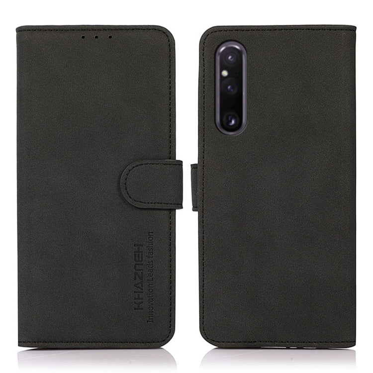 Matte texture leather phone case with folio flap and magnetic strap, black finish.