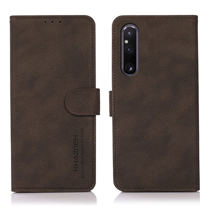 Matte brown leather phone case with flip cover and holder strap; vertical camera cutout.