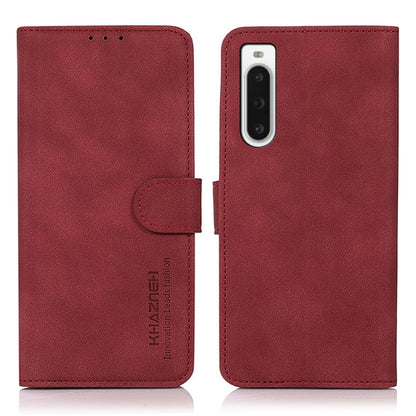 Matte red leather phone case with flip cover and holder strap; camera cutout.