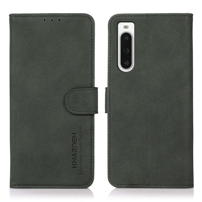 Matte green leather phone case with flip cover and holder strap; vertical camera cutout.
