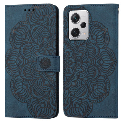 Blue embossed mandala wallet phone case with camera cutout and magnetic strap
