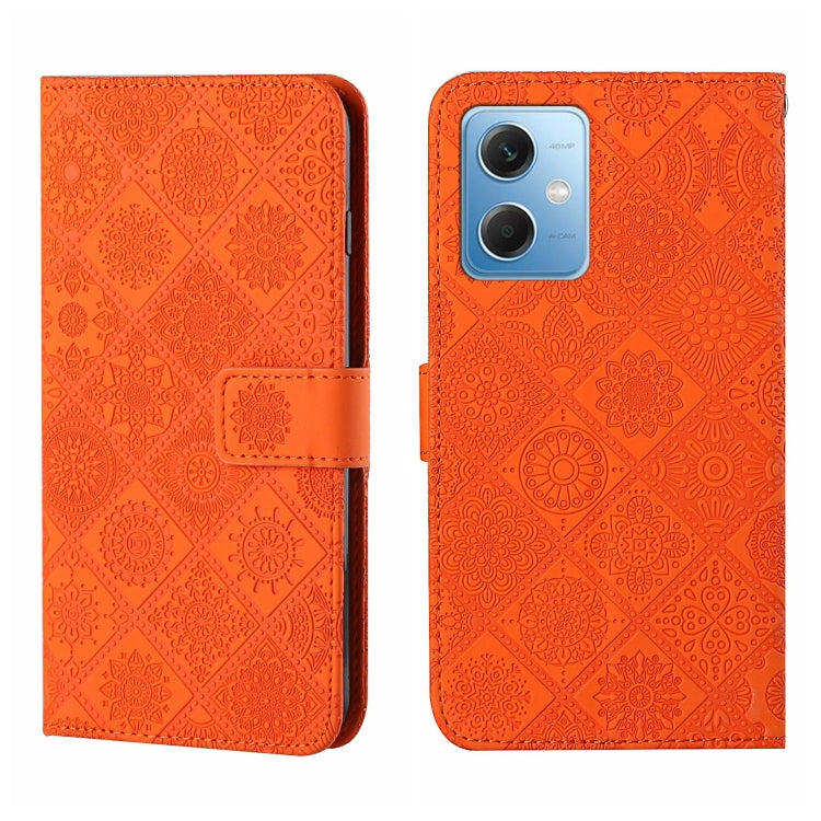 Orange embossed pattern leather wallet-style phone case with magnetic strap and rear camera opening