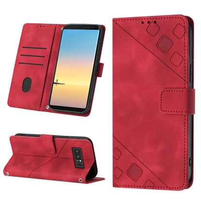 Red embossed leather folio phone case with card slots and fold-out stand, magnetic strap.