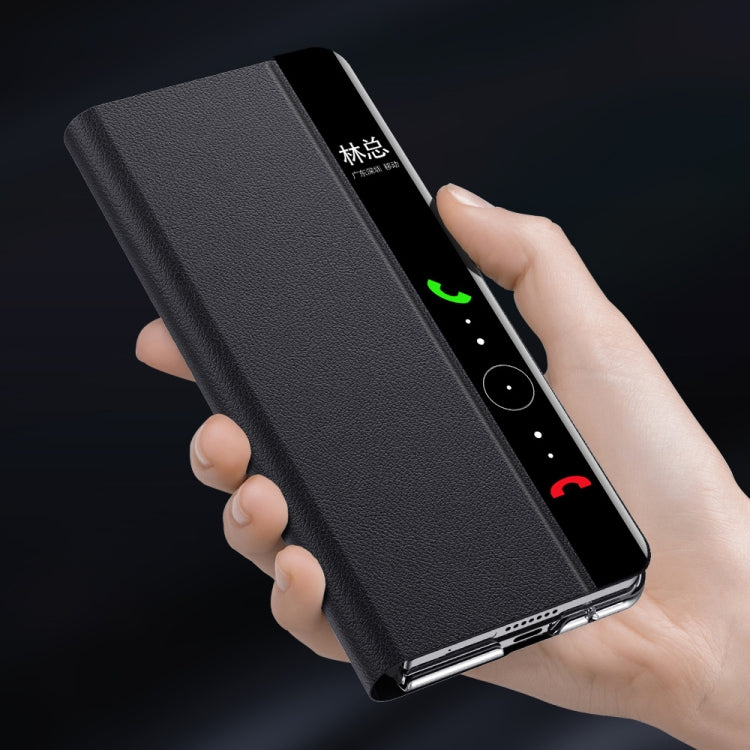 Black magnetic flip phone case in hand with camera opening and side cutouts