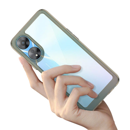 Transparent blue phone case with olive border, held in a hand.