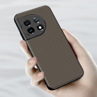 Carbon fiber texture phone case with raised camera cutouts, tan and black, held in hand.
