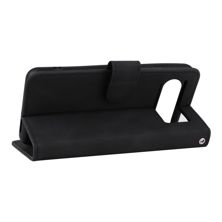 Black magnetic flip leather phone case used as a tabletop stand with viewing angle.