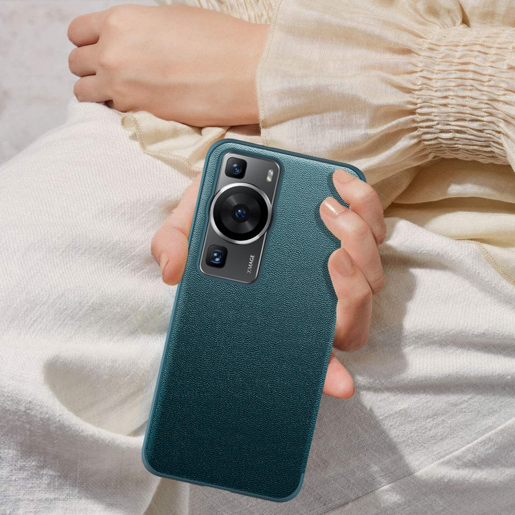 Teal textured shockproof phone case with dual camera cutout, held in hand