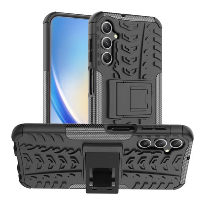 Black tire-texture TPU phone case with PC back, triple-camera cutouts, and stand holder