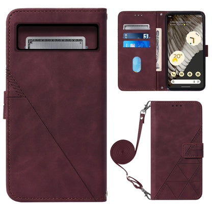 Crossbody flip leather phone case in wine red with embossed diamond pattern and wrist strap
