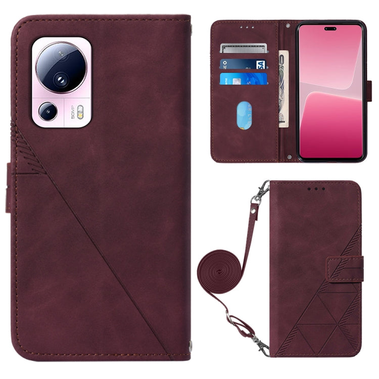 Wine red leather crossbody flip phone case with 3D embossed pattern and wrist strap