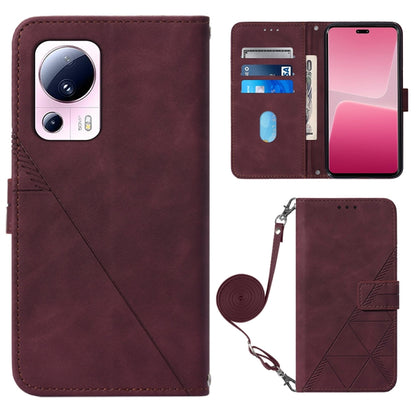 Wine red leather crossbody flip phone case with 3D embossed pattern and wrist strap